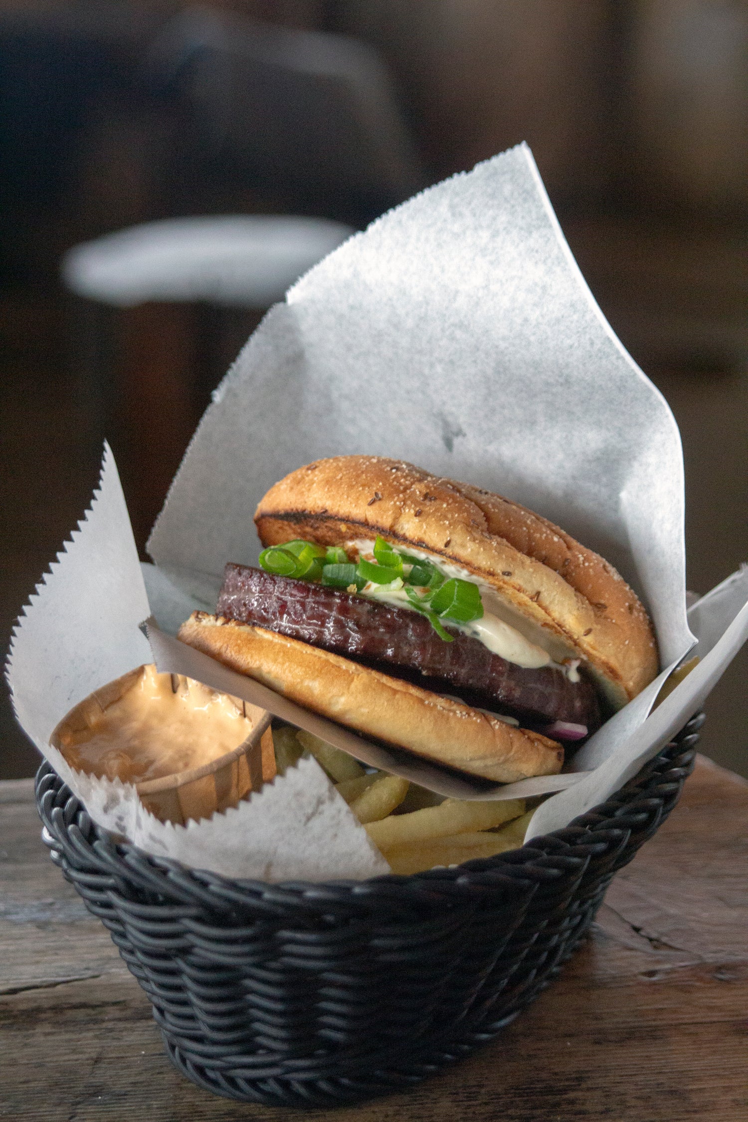 Delicious reindeer burger, fries and dip on basket in Ylläskammi terrace. 